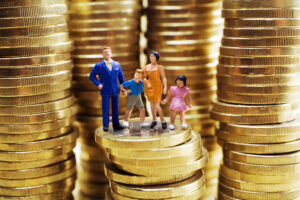 family-figurine-standing-on-stacked-coins-2026-03-26-08-06-55-utc